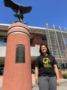 Photo of Jelsy standing in front of Golden Eagle state on Cal State LA campus. 