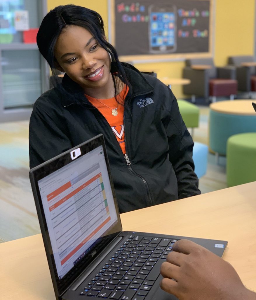 student happily learns about college