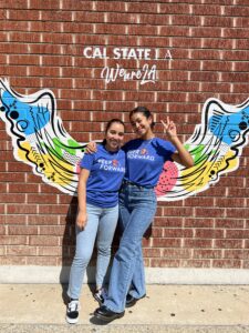 Peer Leaders pose in front of mural