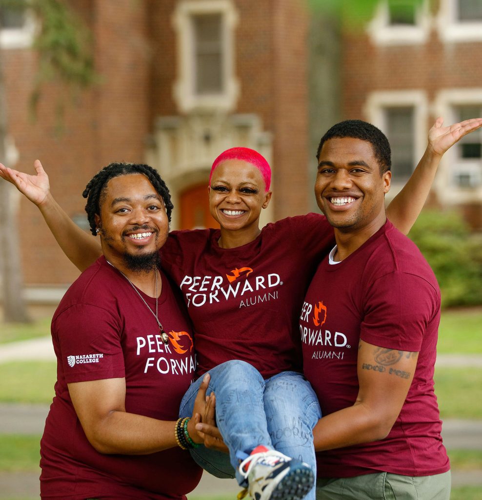 alumni students lift each other up - literally!