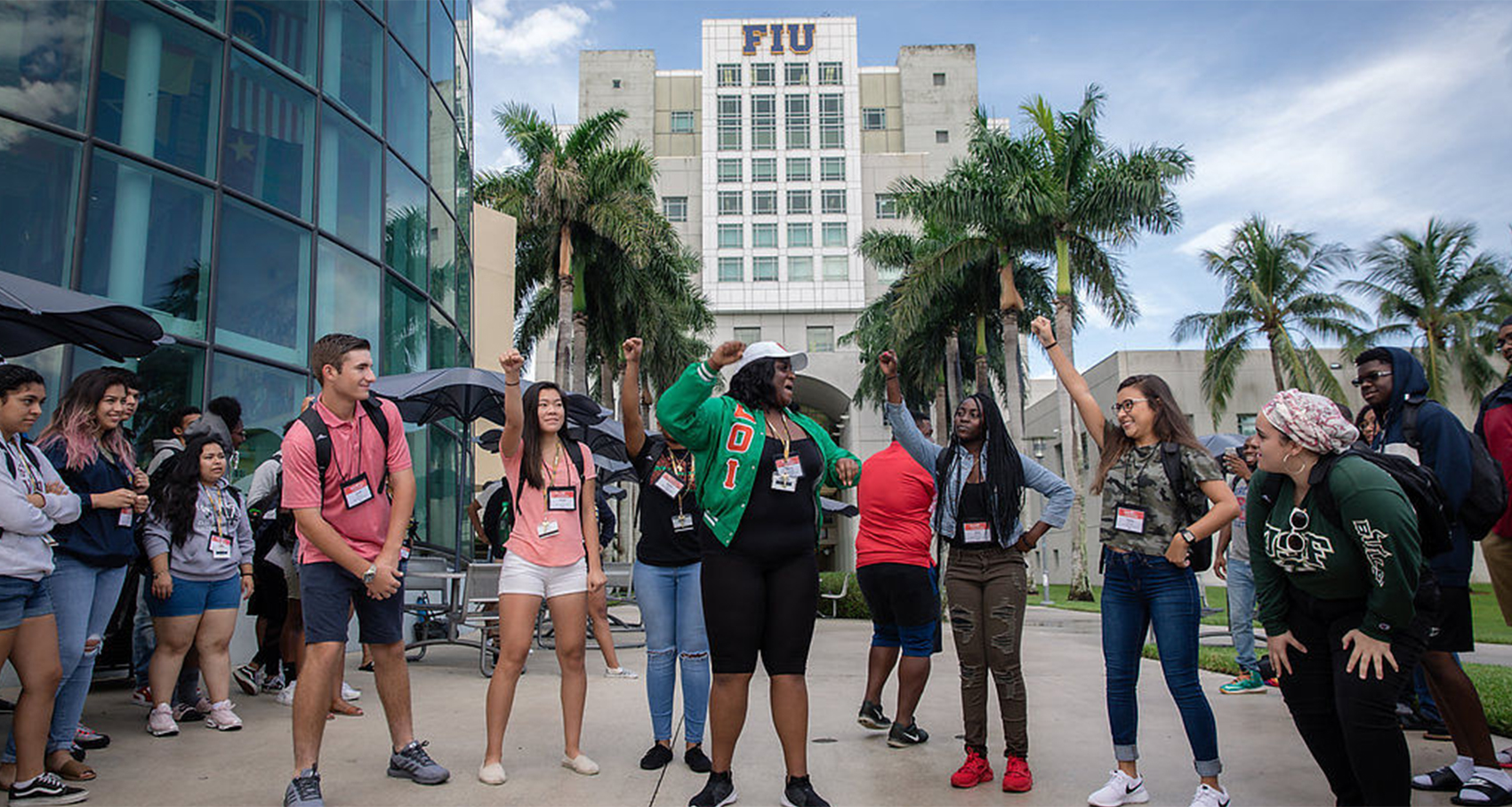 peer leader team throws hands up in the air celebrating college campus workshop!