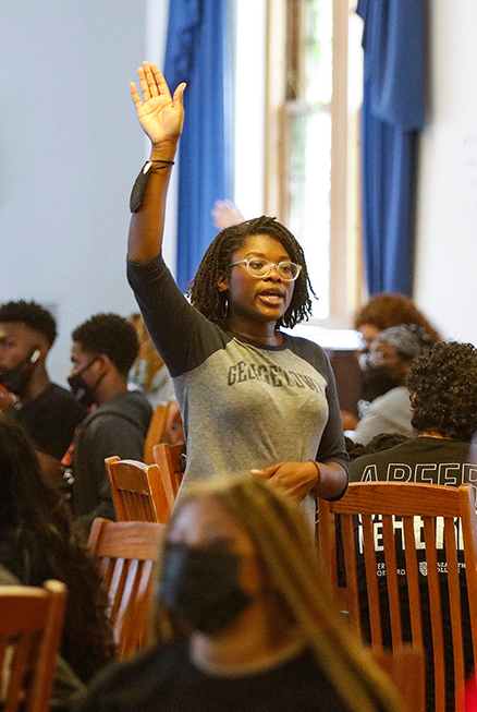 peer leader raises hand at event