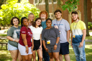 PeerForward alumni poses with Peer Leaders and Writing Coach