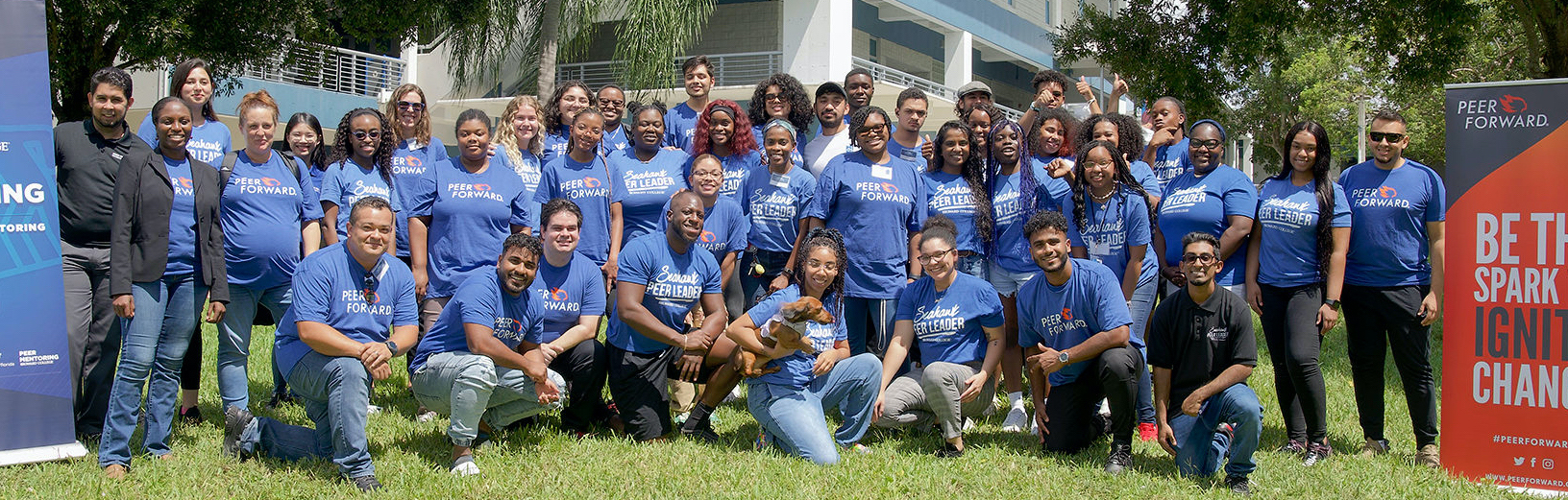 large group of peer leader advisors smile together