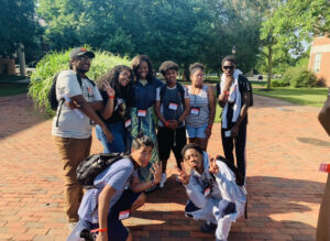 A group of teens with an adult volunteer smiling at the camera.