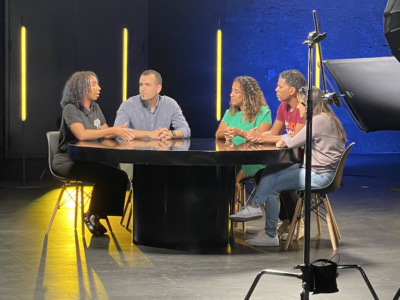 PeerForward CEO Gary Linnen and Peer Leader Erica Luzon sit at a table on a LTX Quest panel