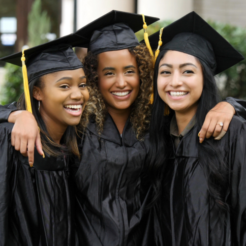 smiling college graduates pose in a group