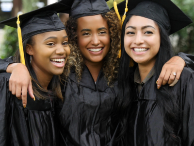 smiling college graduates pose in a group