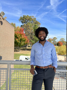 Will Jones, Deloitte volunteer poses outside