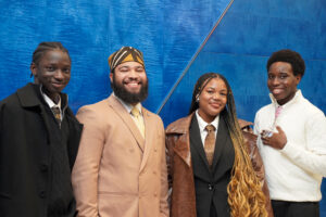 peer leaders pose with advisor and coach